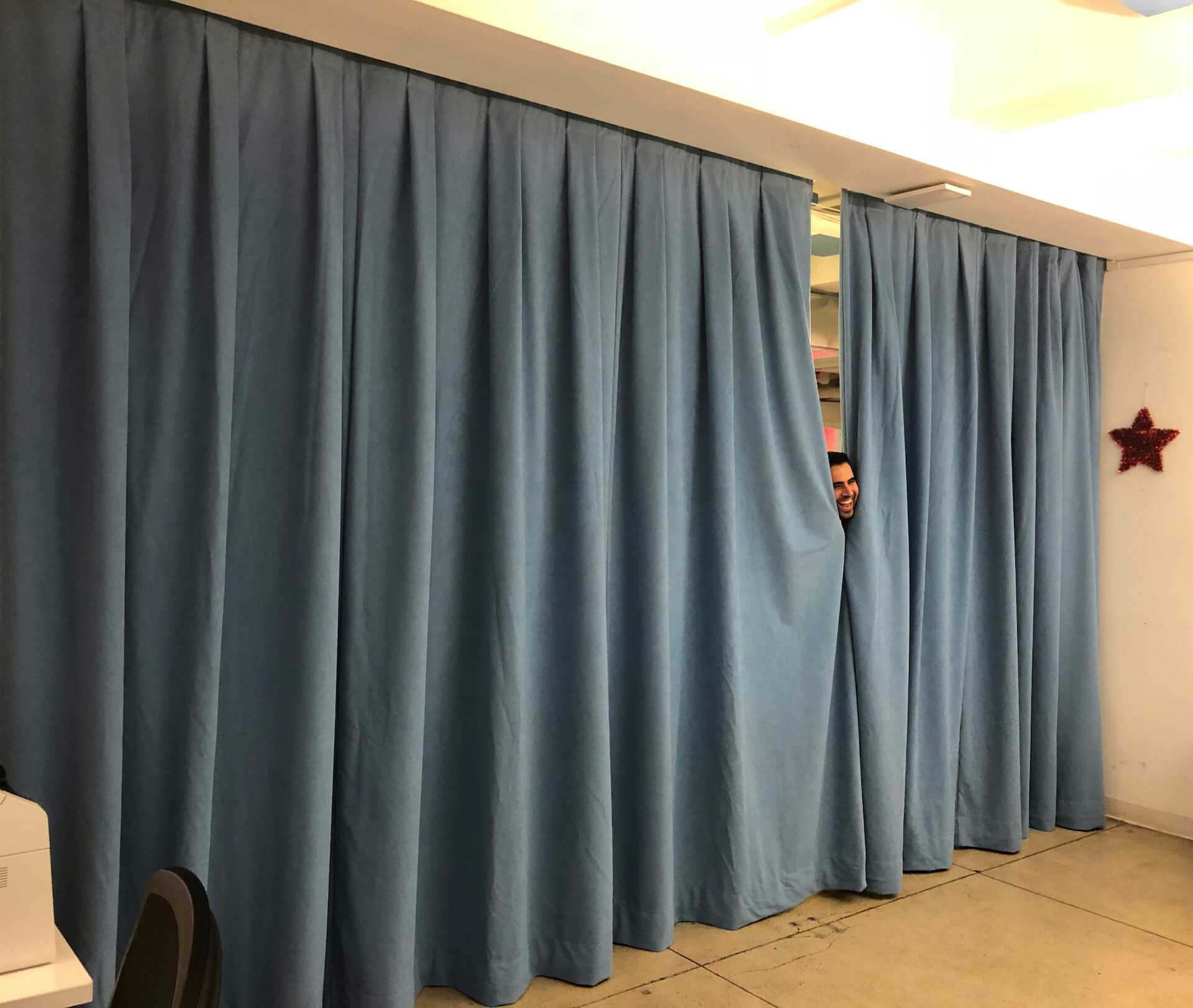 Light Blue Acoustic Curtain and a Smiling Face Peeking Through 😊